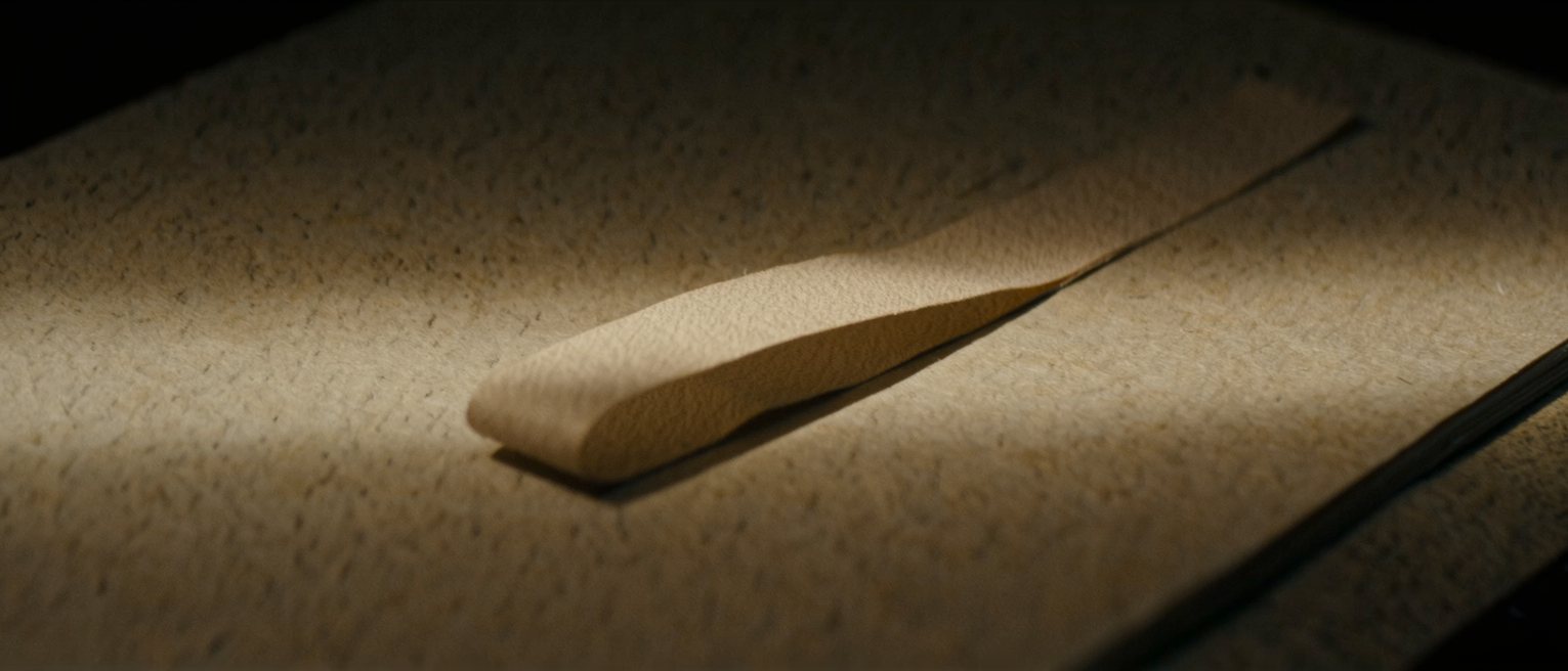 a silk bookmark ribbon drawn out and laid across the page it was holding