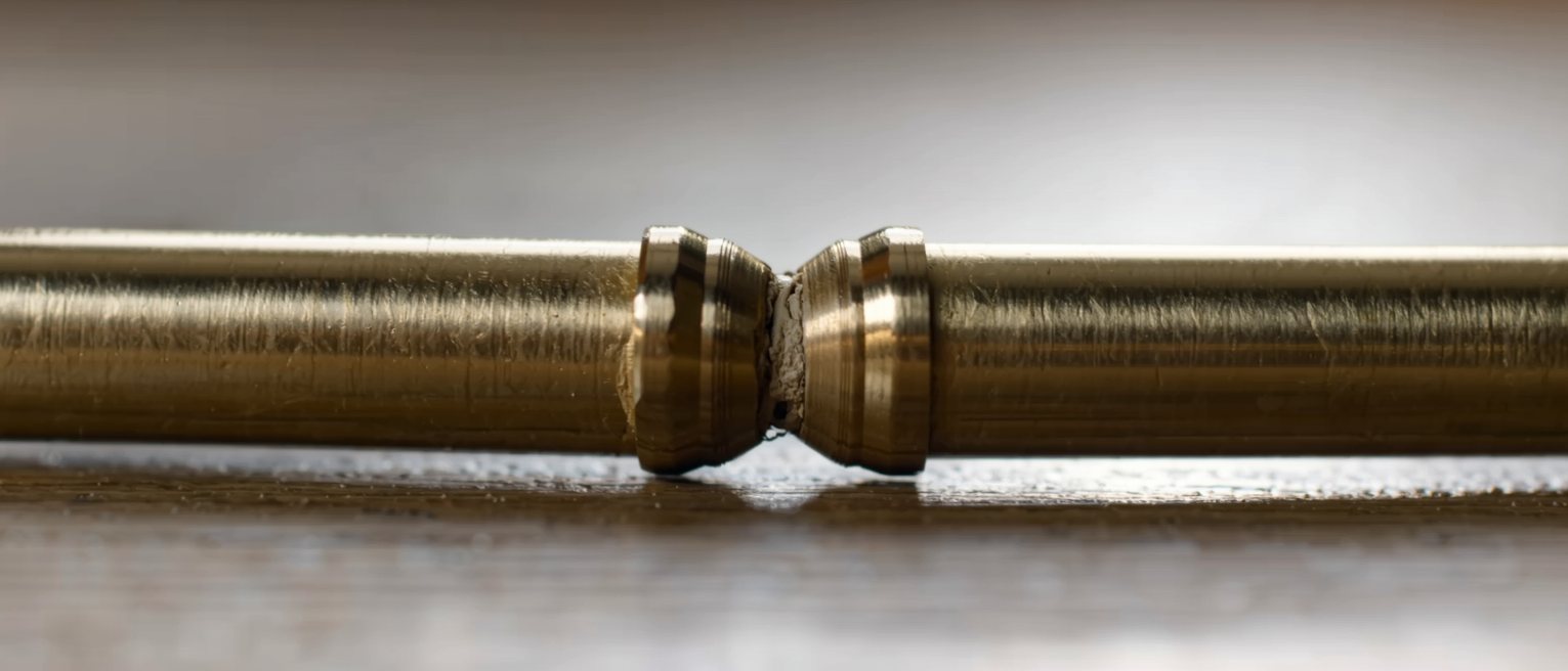 two brass pipes soldered into one line, the joint smoothed over