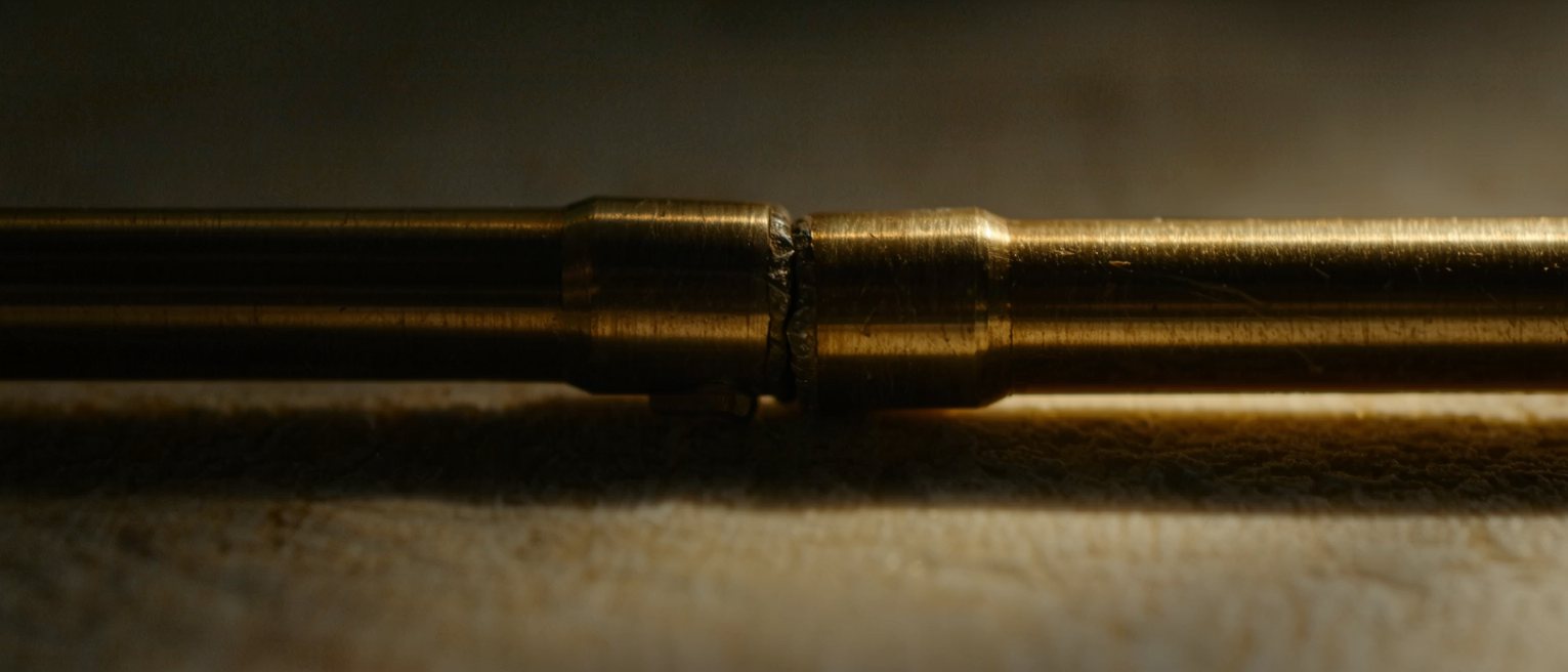 two brass pipes soldered into one line, the joint smoothed over