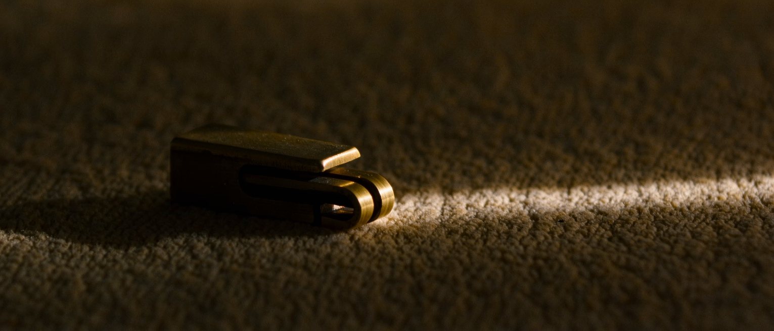 a brass window stay resting on its second peg