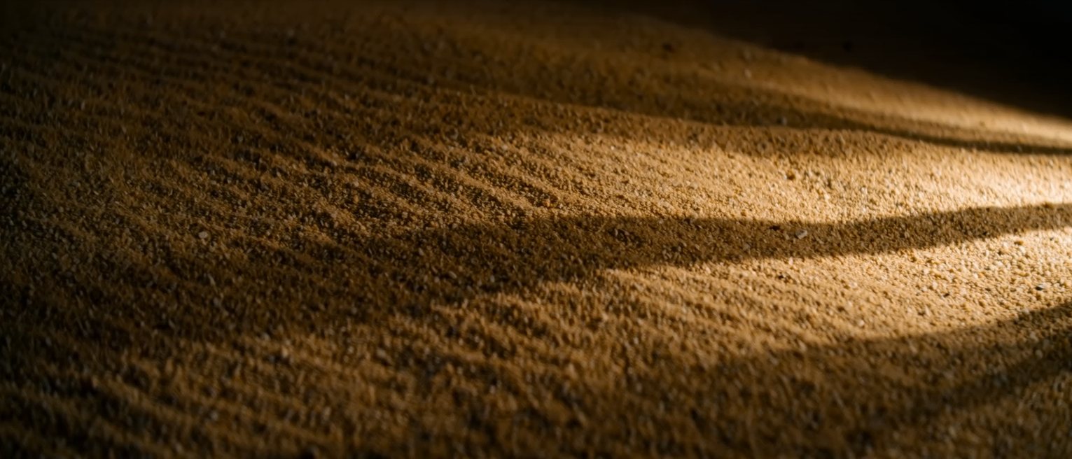 a bed of fine dry sand raked flat and unmarked
