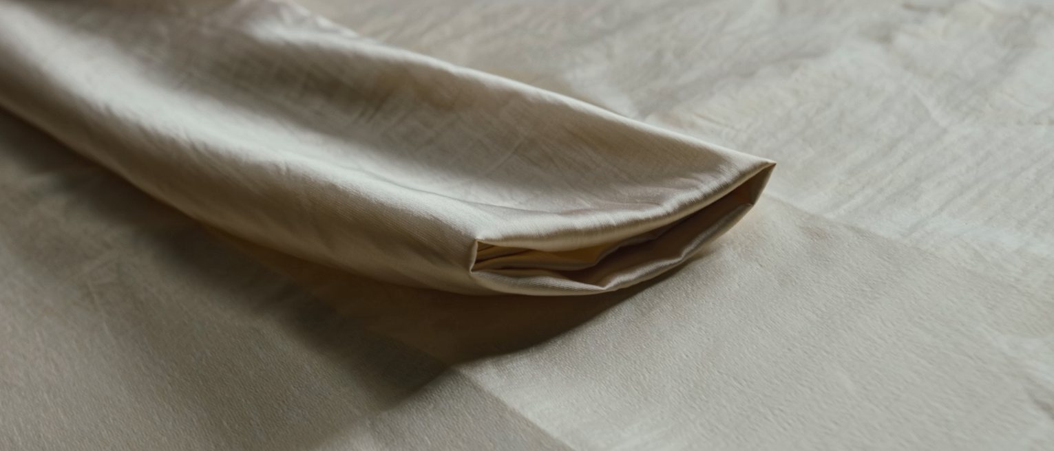 a folded silk kimono sleeve, the lining showing only at the cuff