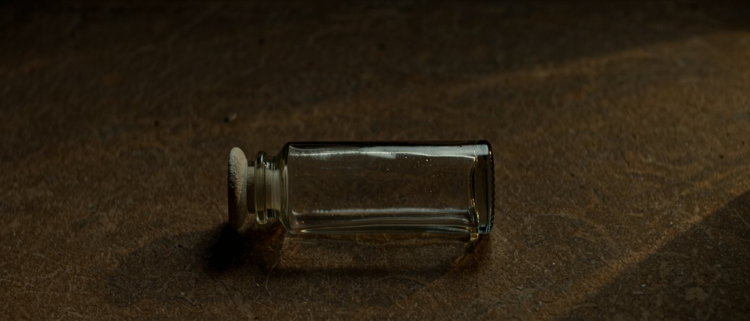 a glass apothecary jar with its ground-glass stopper seated tight, the glass plain and unlabelled