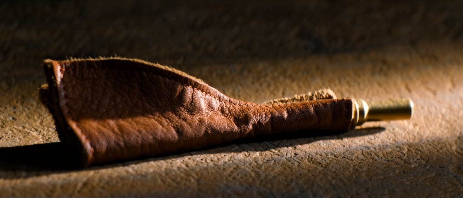 a small pair of bellows, the leather soft with use and the brass nozzle bright