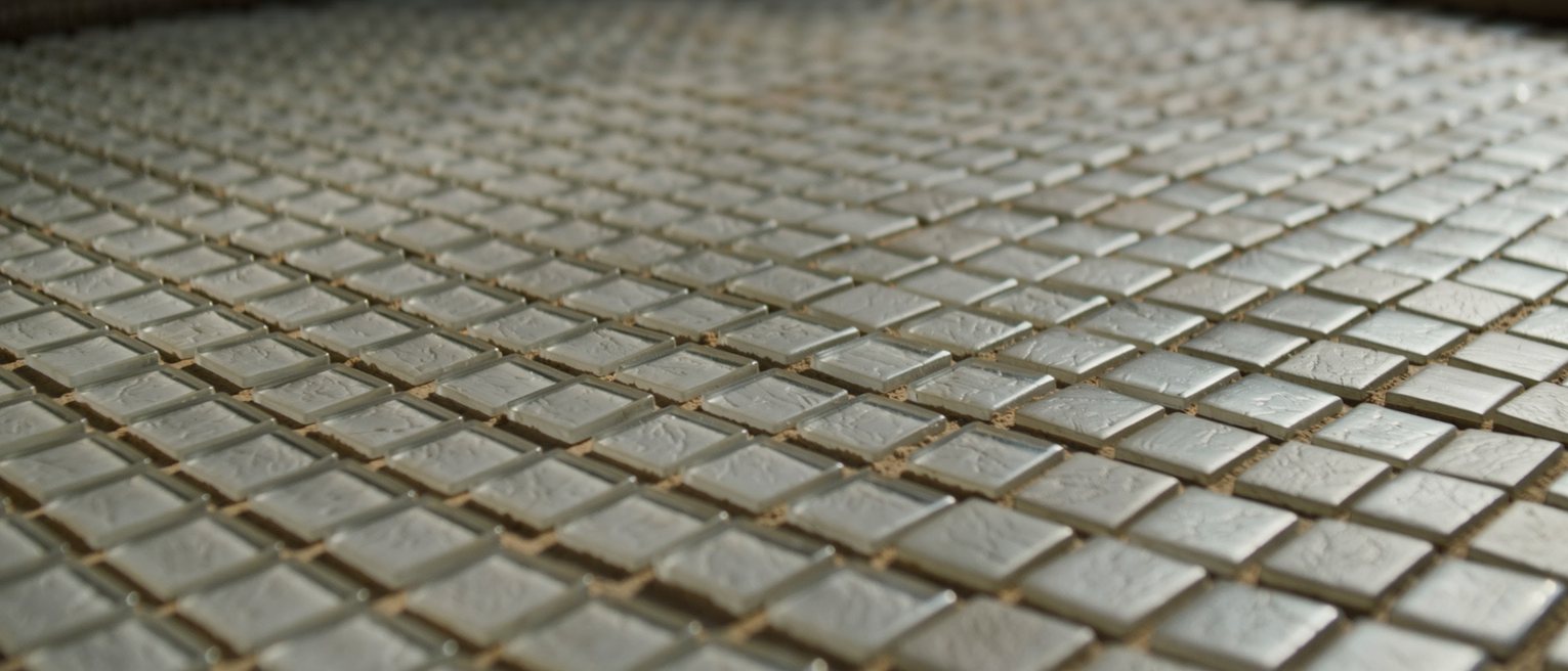 a grid of small square glass tesserae set in mortar, every one the same size