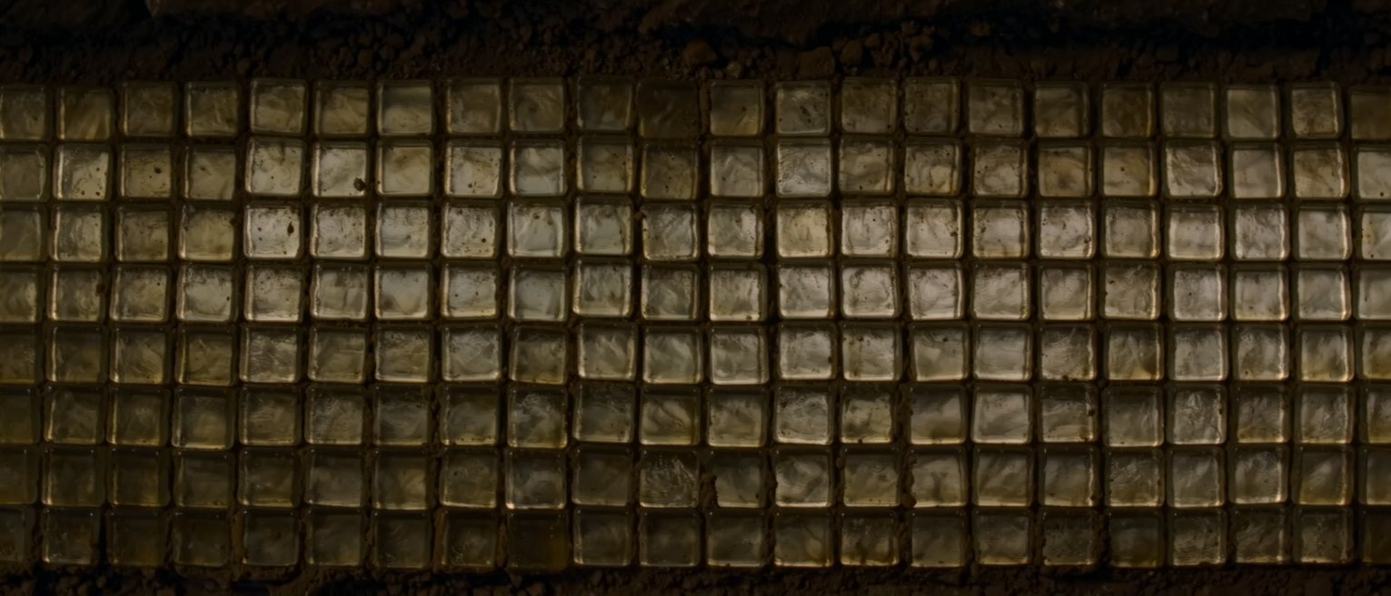 a grid of small square glass tesserae set in mortar, every one the same size