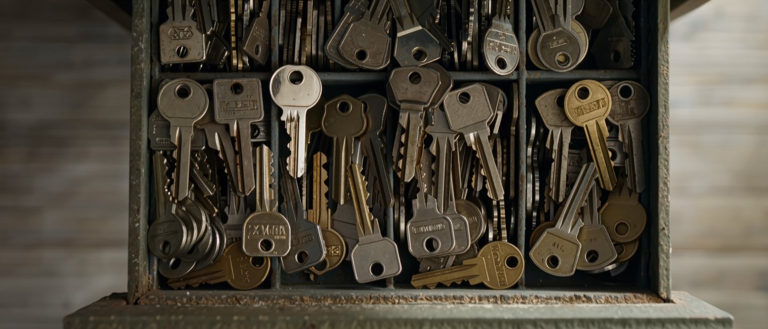 a drawer of assorted keys, no two cut alike, all worn at the same place