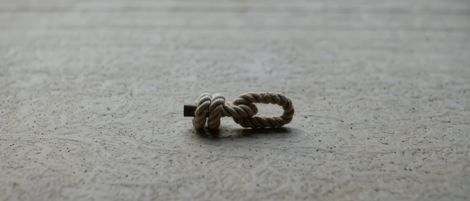 a cleat with a rope turned around it in a figure of eight, holding without a knot