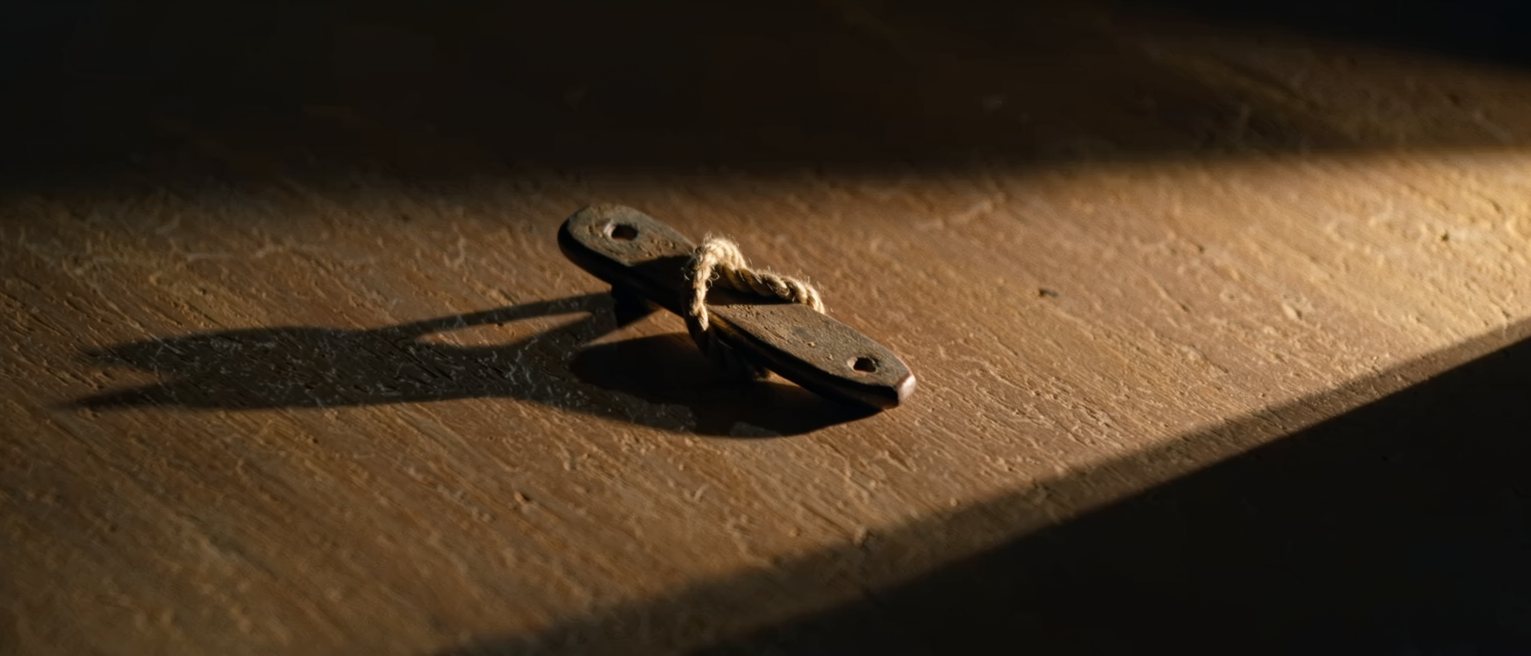 a cleat with a rope turned around it in a figure of eight, holding without a knot
