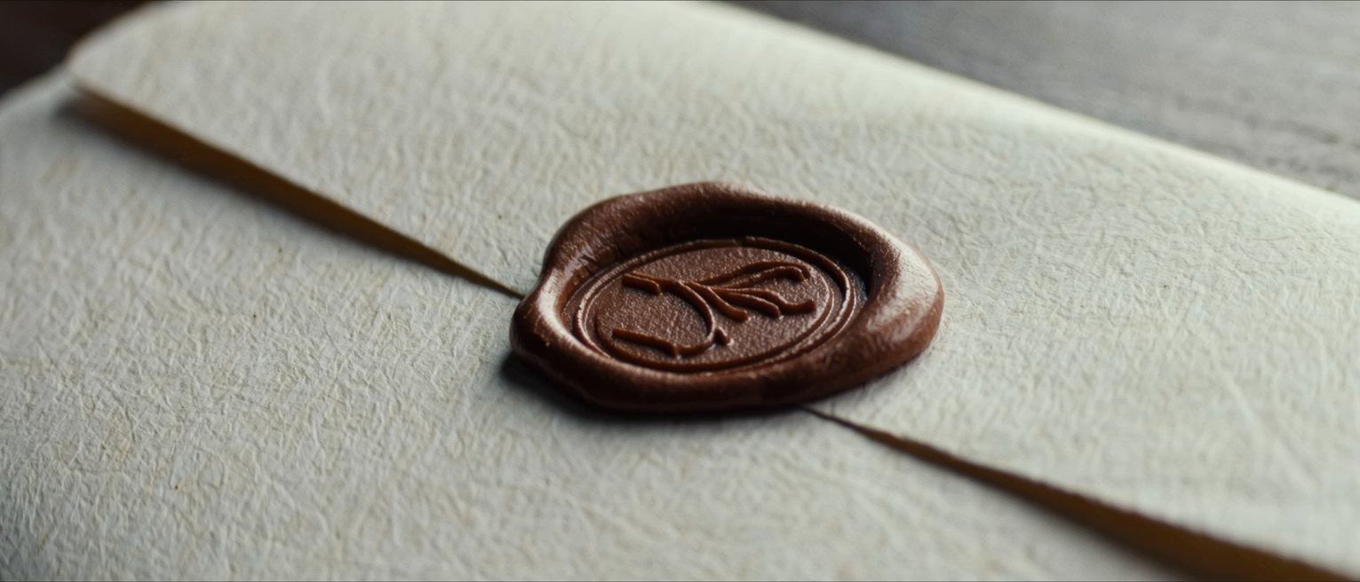 a wax seal pressed into a paper wallet, the impression clean and unbroken